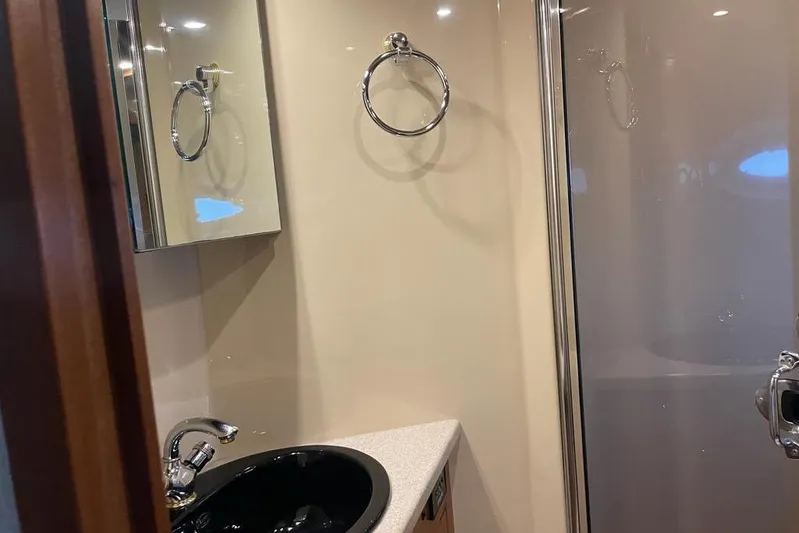  Yacht Photos Pics Bathroom interior of 2003 Cruisers Yachts 5470 Express with sink and shower.