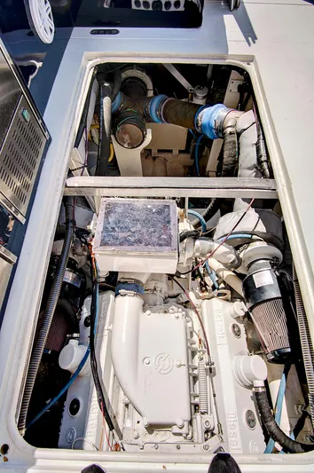 Marchese Yacht Photos Pics Engine compartment of a 1984 Magnum 53 boat with visible components and wiring.
