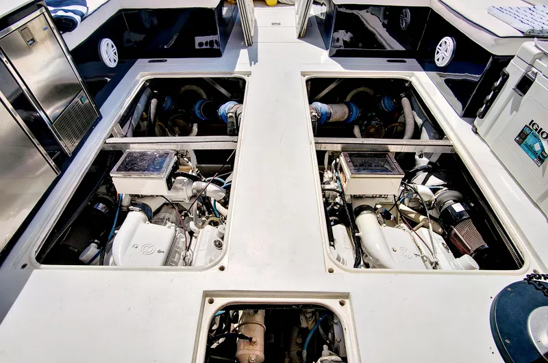 Marchese Yacht Photos Pics Engine compartment of a 1984 Magnum 53 yacht, showcasing dual engines and clean layout.