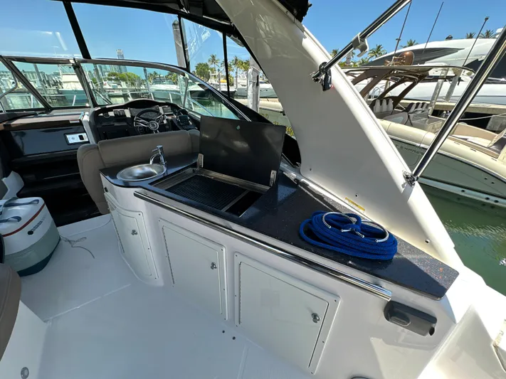 Sick If Needed Yacht Photos Pics 2015 Regal 32 Express yacht interior with kitchenette and sink.