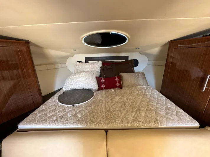Sick If Needed Yacht Photos Pics Interior cabin of 2015 Regal 32 Express with cozy bedding and wooden cabinets.