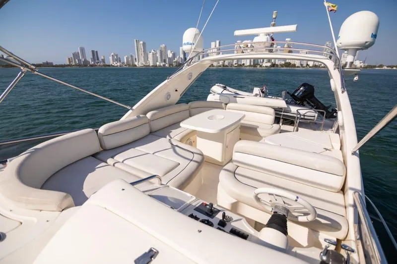  Yacht Photos Pics Luxurious 2007 Azimut 62 yacht with spacious deck, city skyline in background.