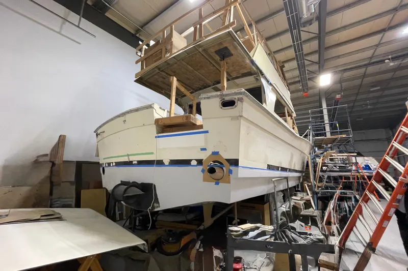  Yacht Photos Pics 1983 Viking Boats Sportfish 46 Sedan Bridge under restoration in a workshop.