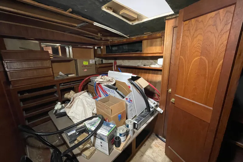  Yacht Photos Pics Interior of 1983 Viking Sportfish 46 Sedan Bridge with cluttered storage and wooden cabinetry.