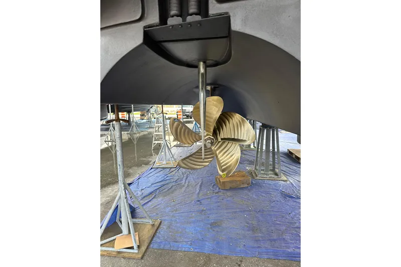  Yacht Photos Pics Propeller of 2016 Hatteras GT63 yacht on dry dock, supported by stands.