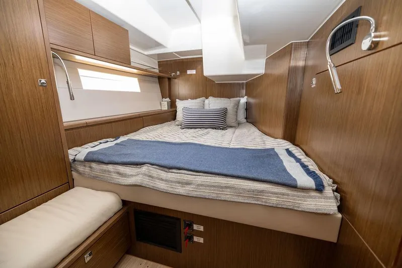 Das Boot Yacht Photos Pics Luxurious cabin interior of 2020 Bavaria C57 yacht with cozy bedding and wooden finish.