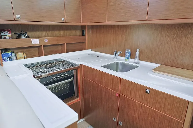 Das Boot Yacht Photos Pics Modern kitchen in 2020 Bavaria C57 yacht with stove, sink, and wooden cabinetry.