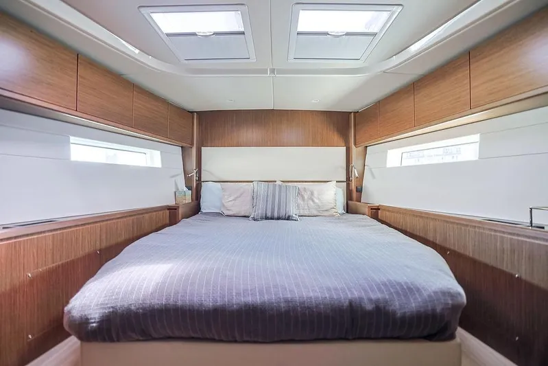 Das Boot Yacht Photos Pics Luxurious 2020 Bavaria C57 yacht bedroom with modern wood paneling and skylights.