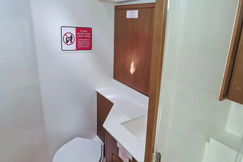 Das Boot Yacht Photos Pics Bathroom interior of 2020 Bavaria C57 yacht with toilet and wooden cabinetry.