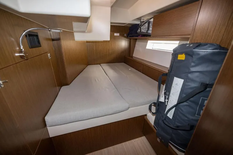 Das Boot Yacht Photos Pics Cozy cabin interior of 2020 Bavaria C57 yacht with wooden finish and compact bed.