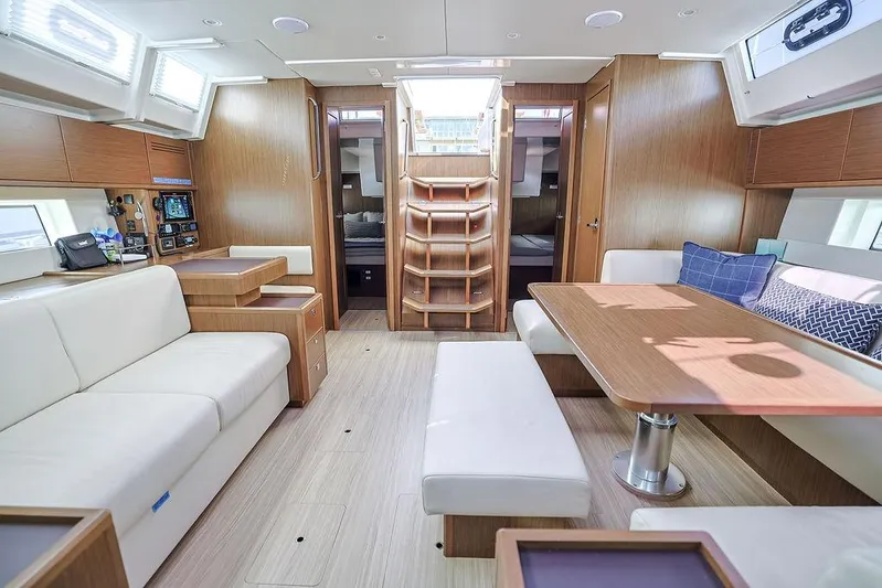 Das Boot Yacht Photos Pics Luxurious interior of 2020 Bavaria C57 yacht with modern wood finish and comfortable seating.