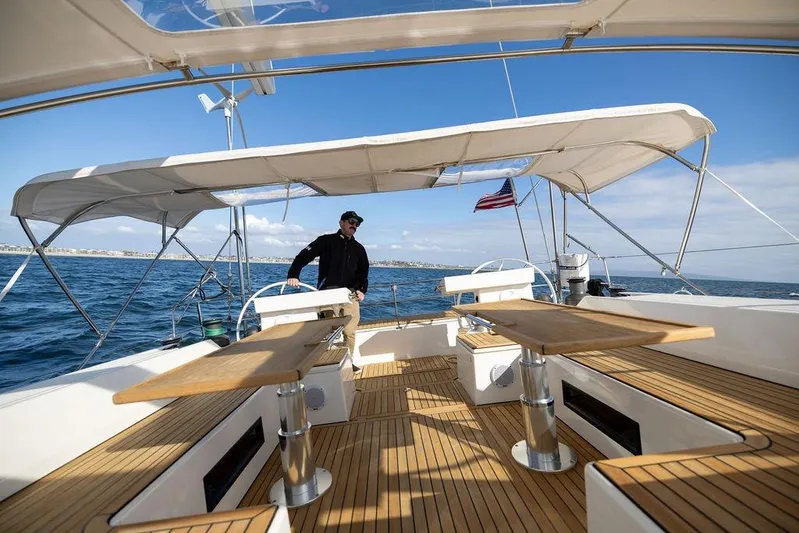 Das Boot Yacht Photos Pics 2020 Bavaria C57 yacht with spacious deck, wooden flooring, and canopy, sailing on open sea.