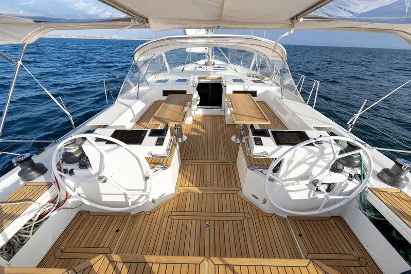 Das Boot Yacht Photos Pics Luxurious Bavaria C57 yacht deck with dual steering wheels, teak flooring, and ocean view.