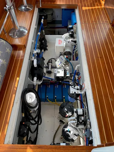 Following Sea Yacht Photos Pics Engine compartment of a 1965 Bertram 56 boat with visible mechanical components.