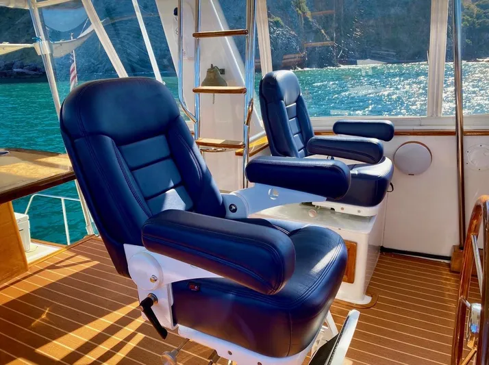 Following Sea Yacht Photos Pics Luxury seating on a 1965 Bertram 56 yacht with ocean view.