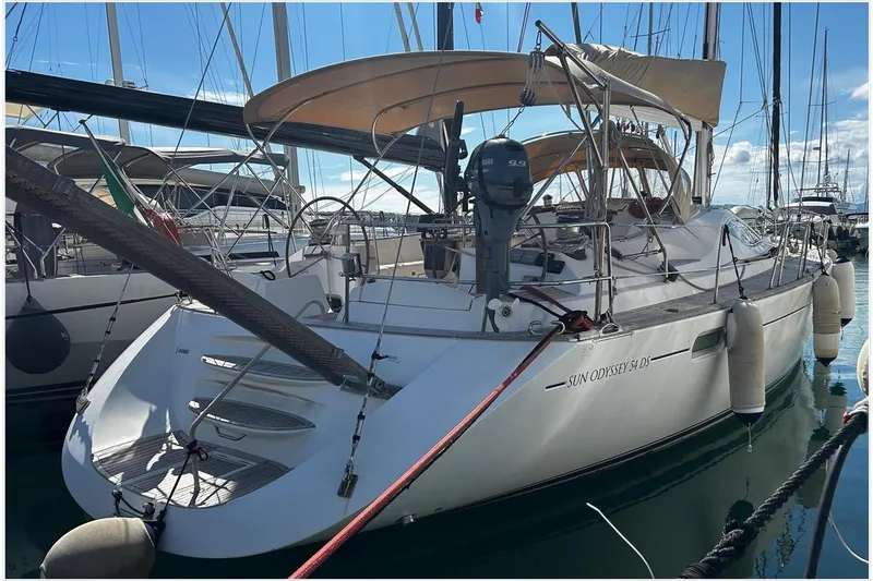  Yacht Photos Pics 2004 Jeanneau Sun Odyssey 54 DS sailboat docked in marina, rear view.
