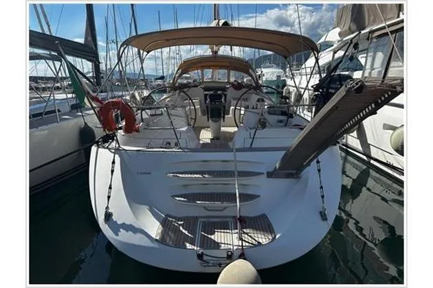  Yacht Photos Pics 2004 Jeanneau Sun Odyssey 54 DS yacht docked in marina, rear view with open cockpit.