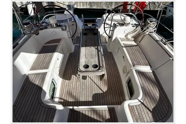  Yacht Photos Pics Cockpit of 2004 Jeanneau Sun Odyssey 54 DS with dual steering wheels and teak flooring.