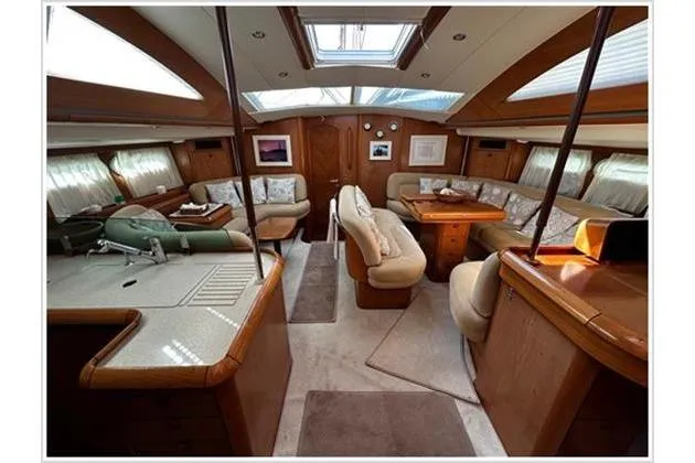  Yacht Photos Pics Luxurious interior of 2004 Jeanneau Sun Odyssey 54 DS yacht with elegant seating and wood finishes.