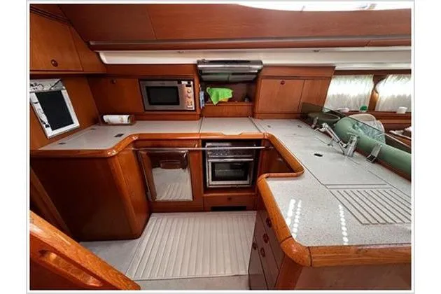  Yacht Photos Pics Luxurious kitchen in 2004 Jeanneau Sun Odyssey 54 DS yacht with modern appliances.