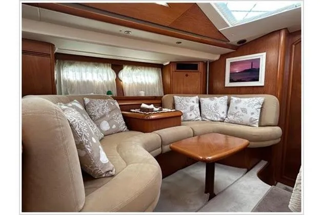  Yacht Photos Pics Luxurious interior of 2004 Jeanneau Sun Odyssey 54 DS yacht with plush seating and elegant decor.