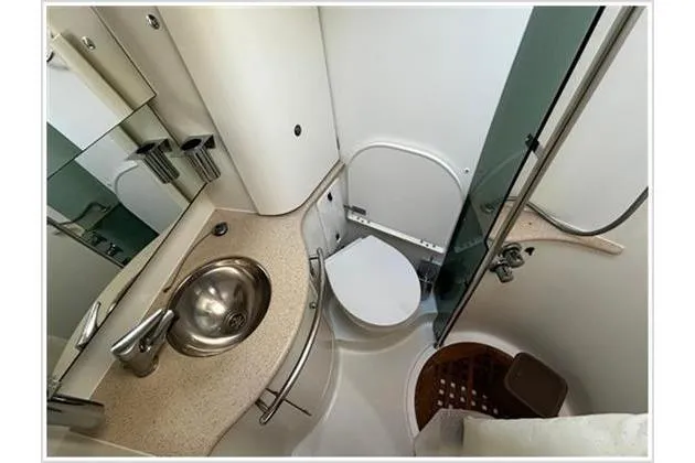  Yacht Photos Pics Compact bathroom in 2004 Jeanneau Sun Odyssey 54 DS yacht, featuring sink and toilet.