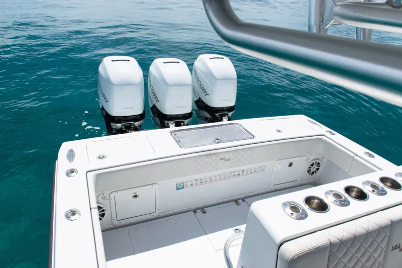  Yacht Photos Pics 2006 SeaVee 340B boat with triple Mercury engines on clear blue water.