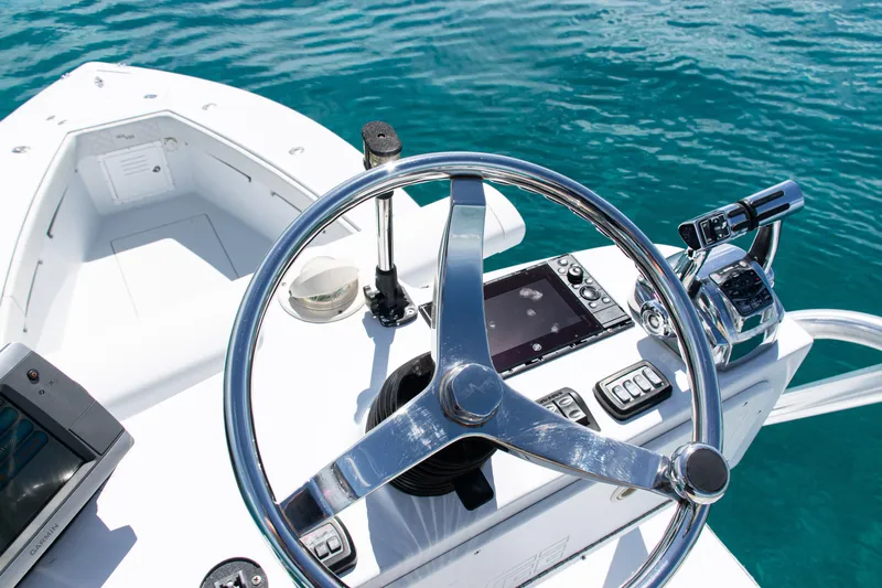  Yacht Photos Pics Steering console of a 2006 SeaVee 340B boat on clear blue water.