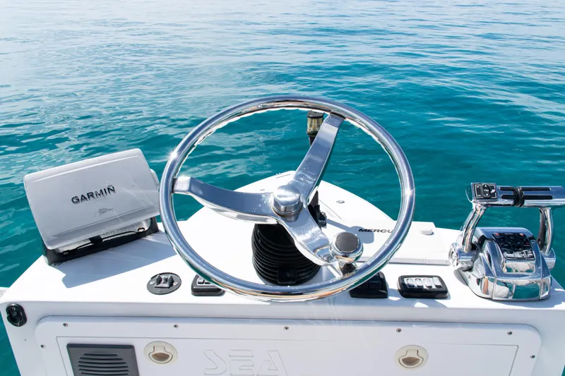  Yacht Photos Pics Steering console of 2006 SeaVee 340B boat with Garmin navigation system on clear water.