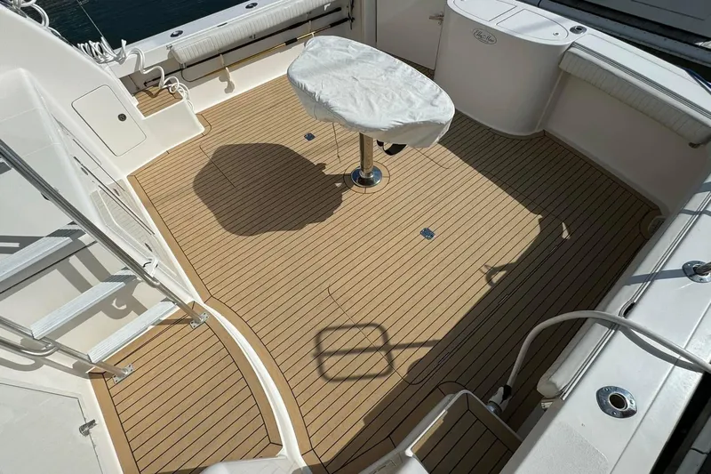 Ella Mae Yacht Photos Pics Henriques 42 Flybridge 2011 boat deck with covered table and seating area.