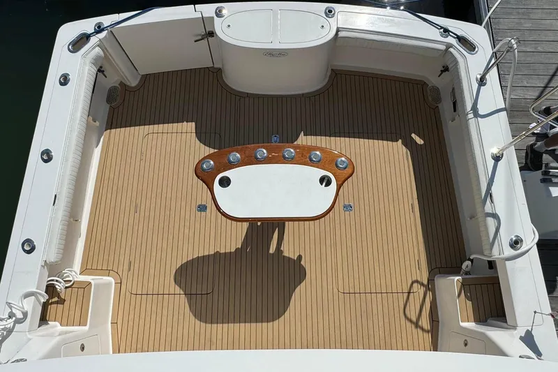 Ella Mae Yacht Photos Pics Henriques 42 Flybridge 2011 boat deck with wooden flooring and central table.