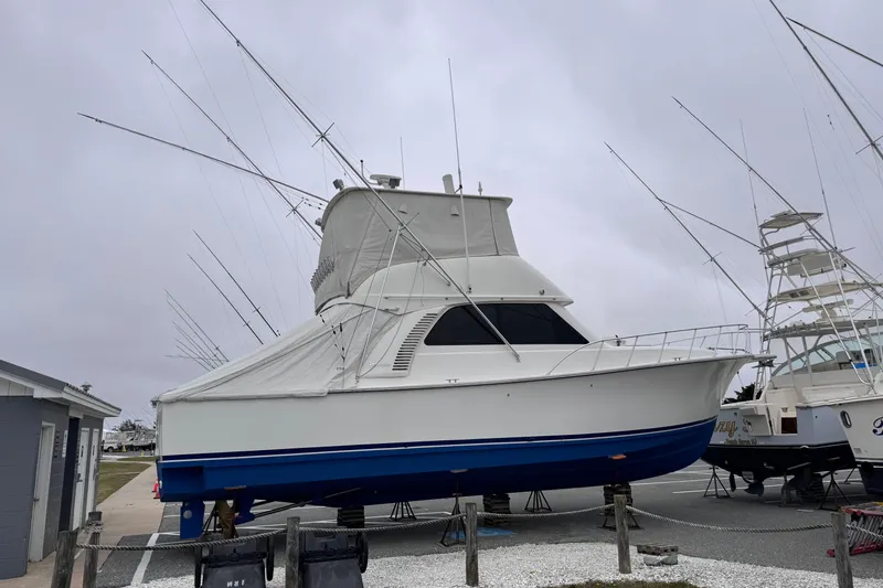 Ella Mae Yacht Photos Pics 2011 Henriques 42 Flybridge boat on dry dock, covered and ready for maintenance.