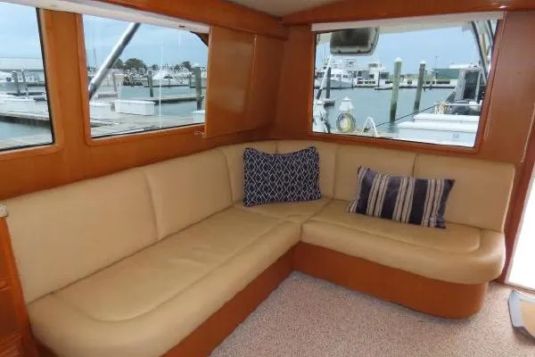 Ella Mae Yacht Photos Pics Interior of 2011 Henriques 42 Flybridge with beige leather seating and decorative pillows.