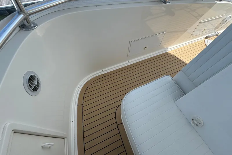 Ella Mae Yacht Photos Pics 2011 Henriques 42 Flybridge boat interior with teak flooring and white seating.