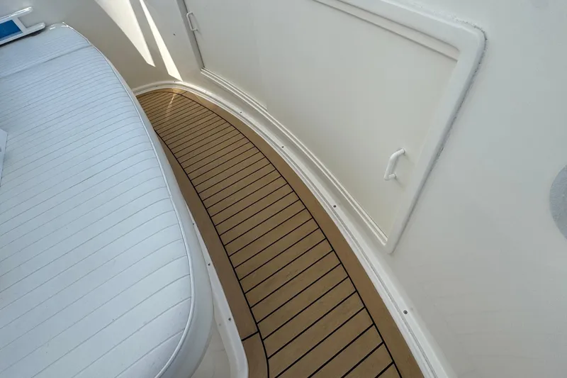 Ella Mae Yacht Photos Pics Henriques 42 Flybridge 2011 boat interior with teak flooring and white seating.