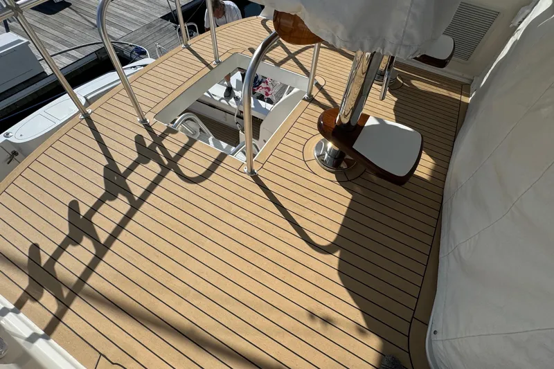Ella Mae Yacht Photos Pics Henriques 42 Flybridge 2011 boat deck with wooden finish and metal railings.