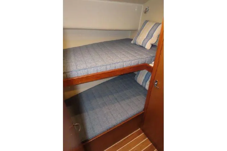 Ella Mae Yacht Photos Pics Bunk beds in 2011 Henriques 42 Flybridge cabin with striped bedding.