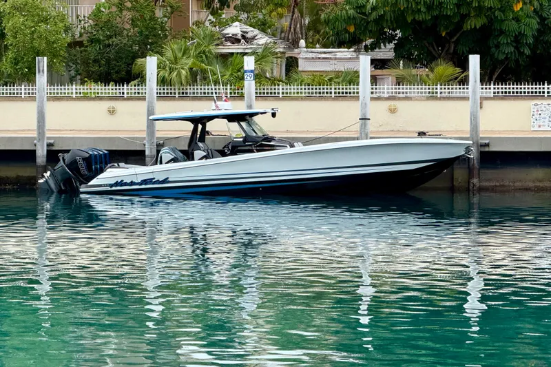  Yacht Photos Pics 2024 Nor-Tech 400 Supersport boat docked in clear turquoise water.