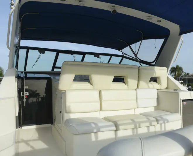 Sprout Yacht Photos Pics 1995 Tiara Yachts 4000 Express with white seating and blue canopy.