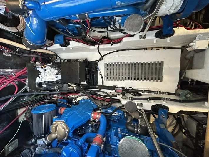 Sprout Yacht Photos Pics 1995 Tiara Yachts 4000 Express engine room with blue engine components and wiring.