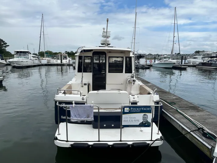  Yacht Photos Pics 2014 Cutwater C-30 Sedan docked at marina, surrounded by other boats.