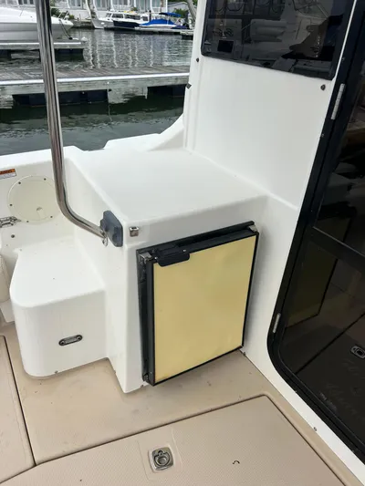  Yacht Photos Pics 2014 Cutwater C-30 Sedan boat interior with compact fridge and dock view.
