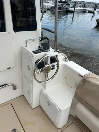  Yacht Photos Pics 2014 Cutwater C-30 Sedan helm station with steering wheel, docked by the water.