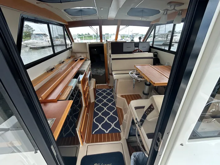  Yacht Photos Pics Interior of 2014 Cutwater C-30 Sedan boat with wood accents and seating area.