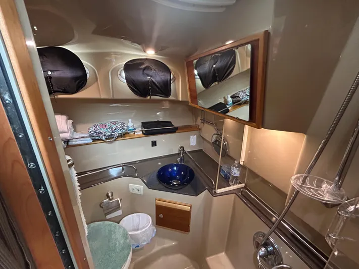  Yacht Photos Pics 2014 Cutwater C-30 Sedan bathroom with modern fixtures and blue glass sink.