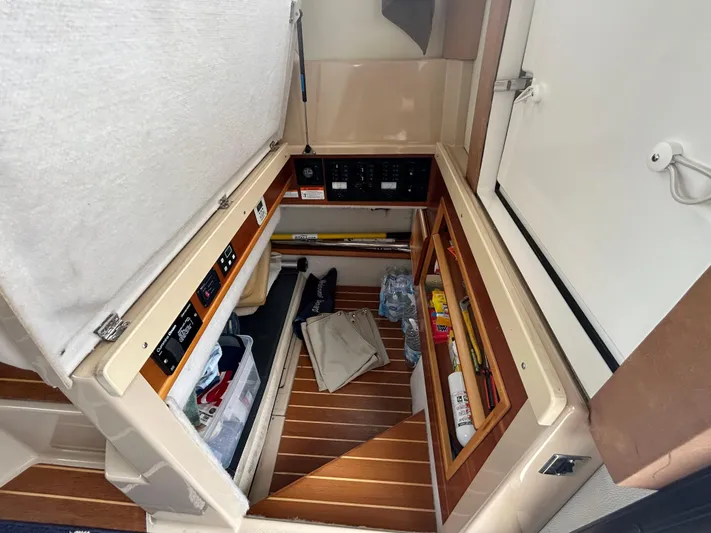  Yacht Photos Pics Interior storage compartment of a 2014 Cutwater C-30 Sedan boat, featuring organized shelves and equipment.