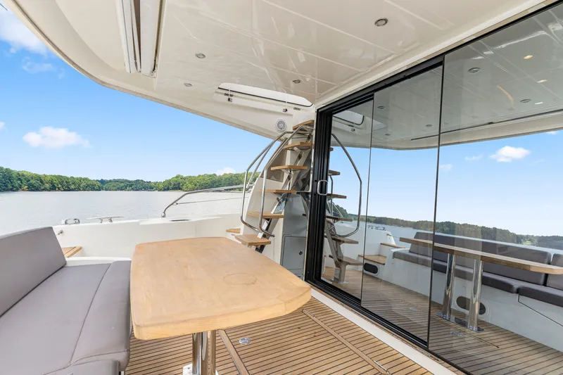  Yacht Photos Pics Luxurious 2017 Prestige 500 yacht deck with seating, table, and scenic water view.