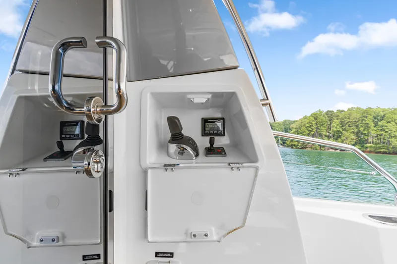  Yacht Photos Pics Control panel of a 2017 Prestige 500 yacht with scenic lake view.