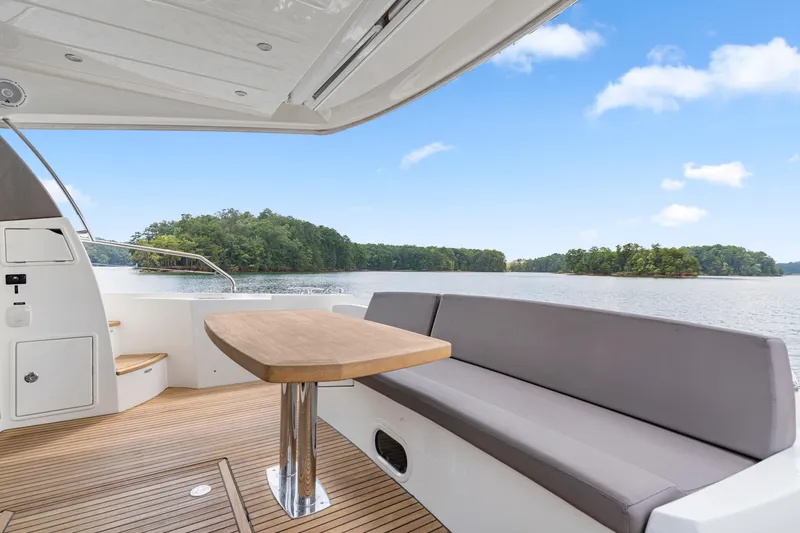  Yacht Photos Pics 2017 Prestige 500 yacht deck with seating, table, and scenic lake view.
