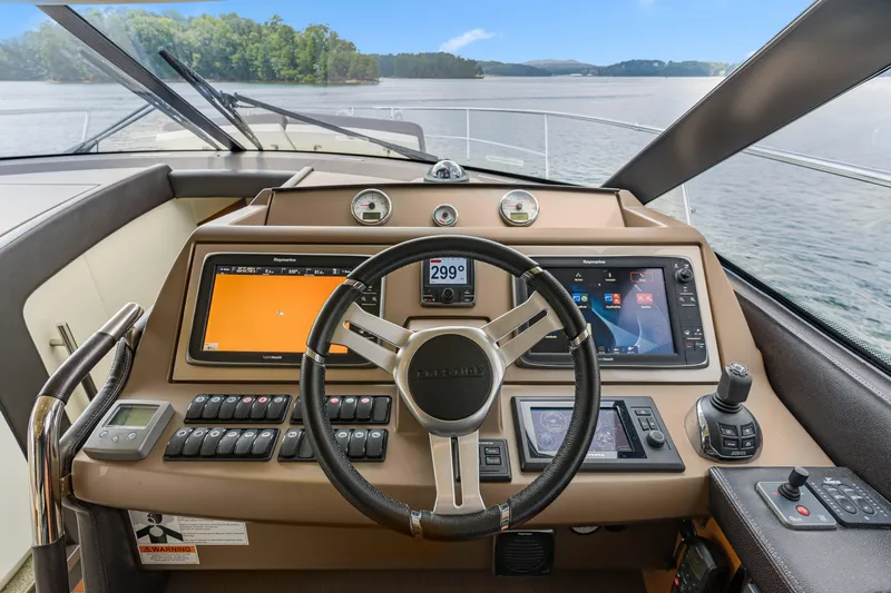  Yacht Photos Pics Cockpit of 2017 Prestige 500 yacht with advanced navigation controls and scenic water view.